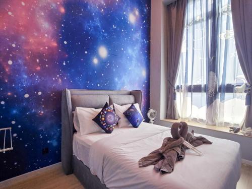 a bedroom with a space mural on the wall at Sunway Grid Loft Suite by Nest Home【Olympic Size Pool】 in Kampong Pendas