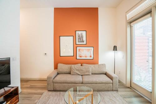 a living room with a couch and a glass table at Boulevard Stays Modern Roosevelt Row Suite 1BR Pool Gym 3 in Phoenix