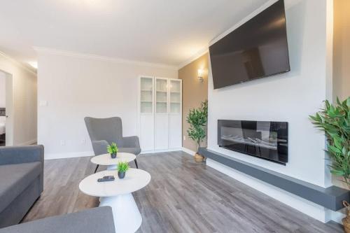a living room with a couch and a fireplace at Soothing Minimalist Escape - Suite with Balcony & Fireplace in Vancouver