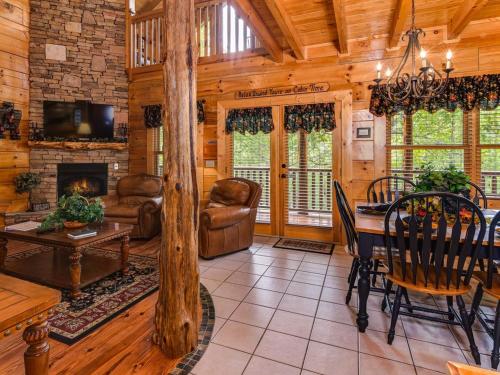 a living room with a table and a fireplace at One More Night in Waldens Creek