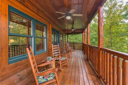a porch with rocking chairs and a ceiling fan at One More Night in Waldens Creek