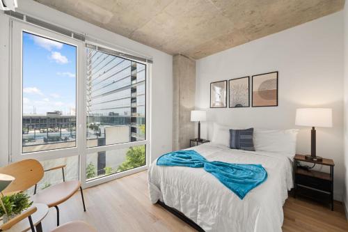 a bedroom with a bed and a large window at 3BR City Escape Bright Sleek Spacious in Chicago