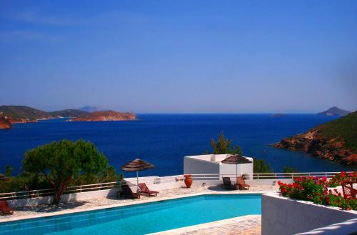 a swimming pool with a view of the ocean at Patmos Paradise Hotel in Kámbos