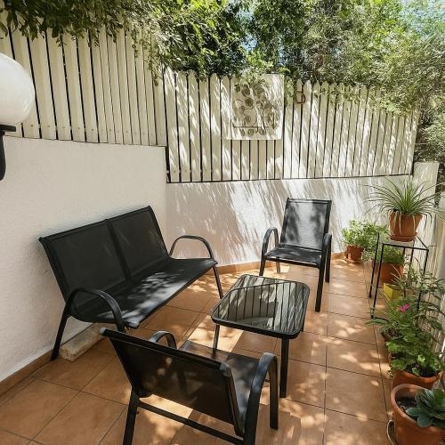 two chairs and a couch on a patio at Blue Emerald in Haifa