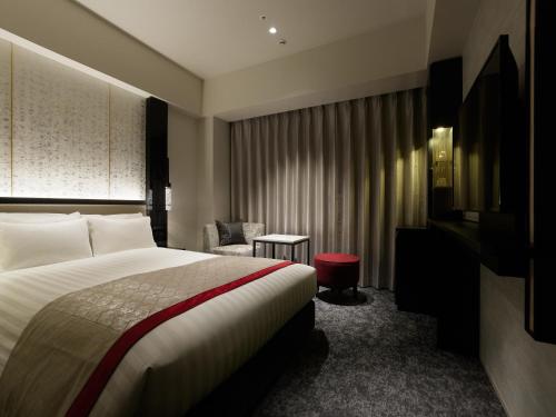 Кровать или кровати в номере Mitsui Garden Hotel Fukuoka Nakasu