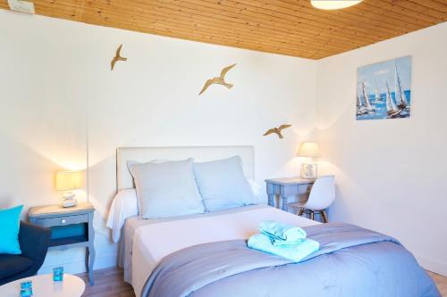 a bedroom with a bed with blue towels on it at Les chambres de Ma'nous - Dordogne in Mouleydier