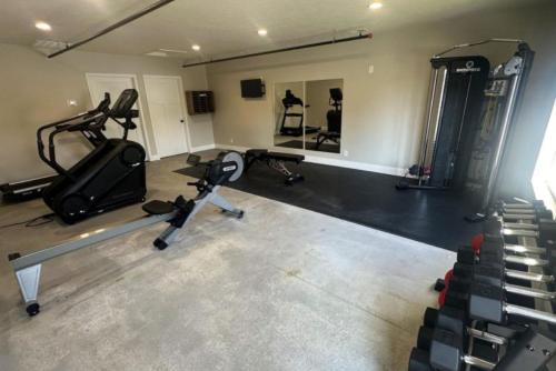 a gym with several tread machines and a mirror at 2 Beds, Built-in Office, Gated Entry in Council Bluffs