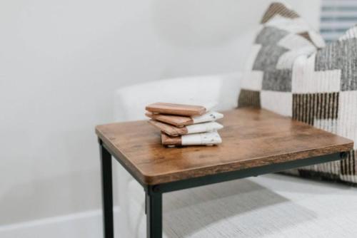 a wooden table with a pile of towels on top at 2 Beds, Built-in Office, Gated Entry in Council Bluffs