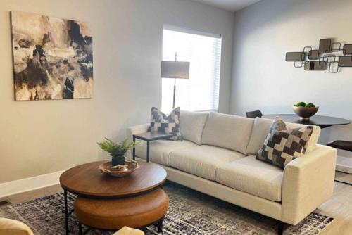 a living room with a couch and a table at 2 Beds, Built-in Office, Gated Entry in Council Bluffs