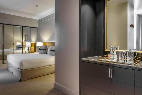 a hotel room with a bed and a bathroom at Casa Lucia Member of Melia Collection in Buenos Aires