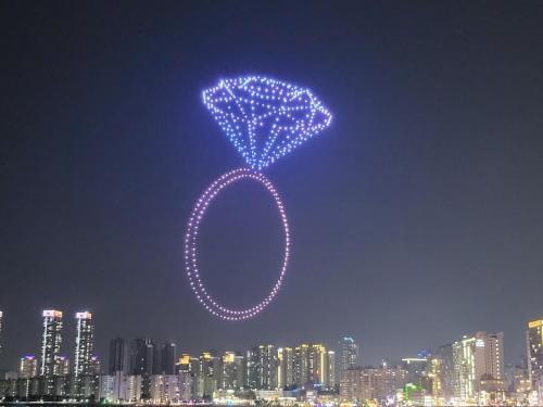 a sign in the sky over a city at night at All New Diamond House in Busan