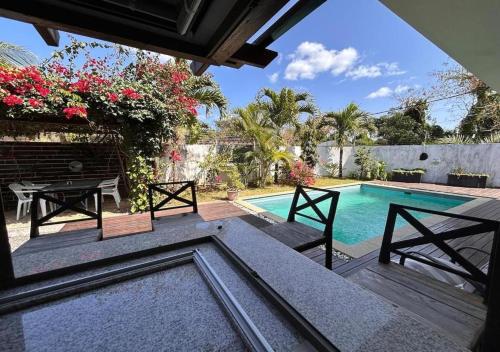 a patio with a table and a swimming pool at Sunshine Serenity Villa in Grand Baie