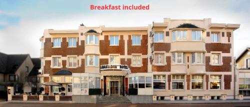 a large brick building on a city street at Ambassador Hotel in De Panne