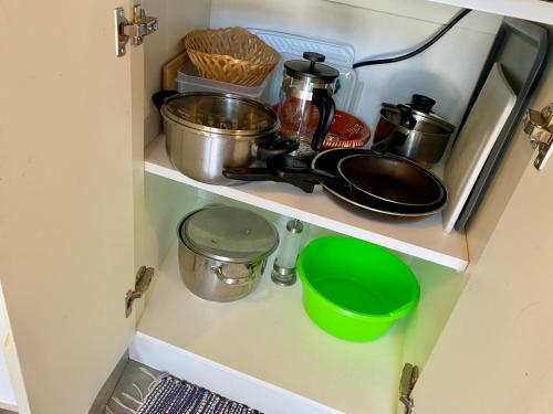a cupboard with pots and pans and other kitchen items at CASA DO PENEDO - Um Segredo na Serra da Estrela in Quintãs de Baixo
