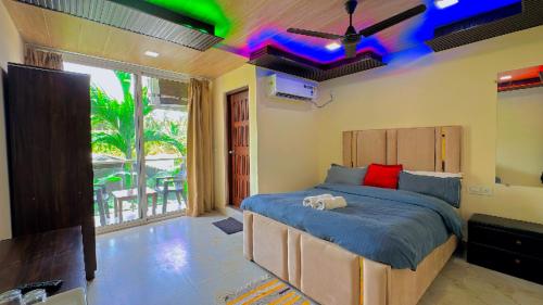 a bedroom with a large bed with a blue comforter at Seaside Stay in Arambol