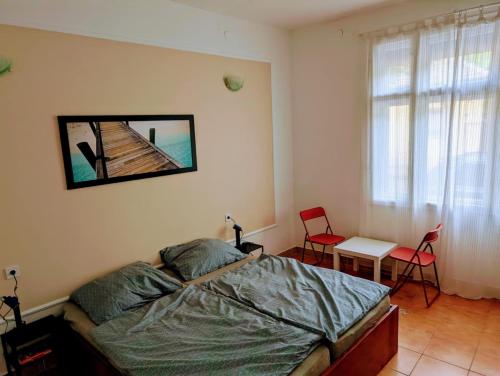 a bedroom with a bed and a table and chairs at B59 guesthouse in Budakalász