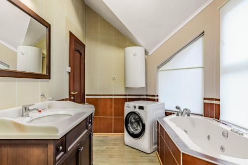 a bathroom with two sinks and a washing machine at Bukovel Hotel in Bukovel