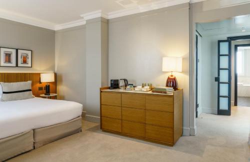 a bedroom with a bed and a dresser with a desk at Casa Lucia Member of Melia Collection in Buenos Aires