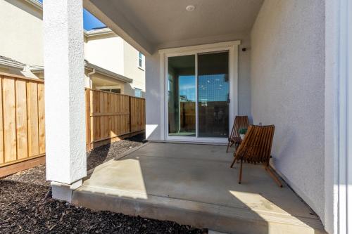 a porch with a chair and a sliding glass door at Spacious 4BR-3BA Cozy and Modern in Elk Grove in Elk Grove