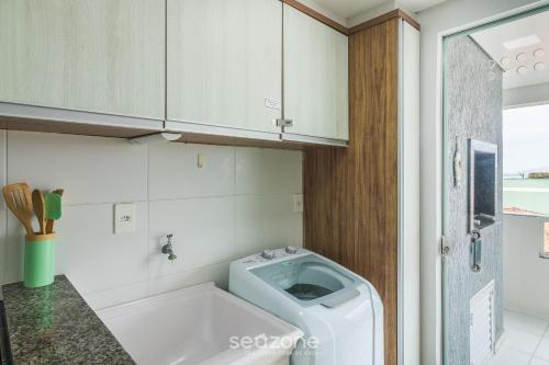 a bathroom with a tub and a toilet in it at Apto Vista Mar Lateral a 120m da Praia EEI0303 in Itajubá