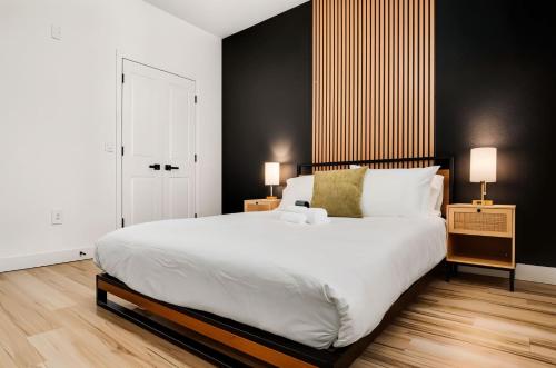 a bedroom with a large white bed and two lamps at Boulevard Stays Chic 1BR Near Stadium Pool Access Gym & Free Parking in Glendale