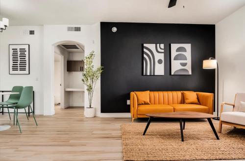 a living room with a couch and a table at Boulevard Stays Chic 1BR Near Stadium Pool Access Gym & Free Parking in Glendale