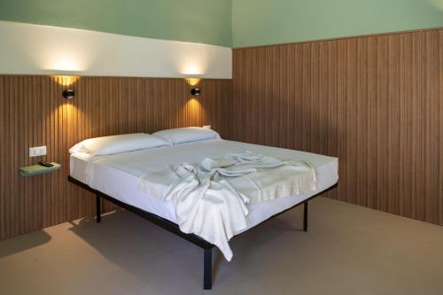 a large bed in a room with wooden walls at Casale della Vittoria in Taranto