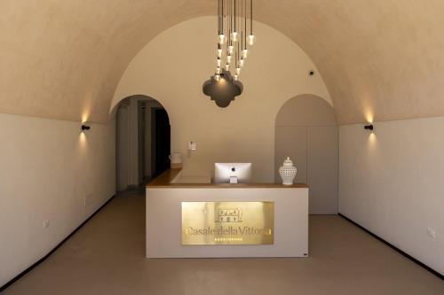a museum with a counter in a room with arches at Casale della Vittoria in Taranto