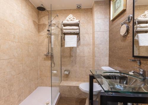 a bathroom with a shower and a sink and a toilet at Durrant House Hotel in Bideford