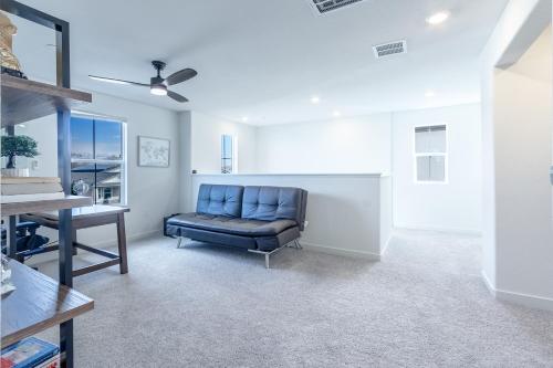a living room with a blue couch and a table at Spacious 4BR-3BA Cozy and Modern in Elk Grove in Elk Grove