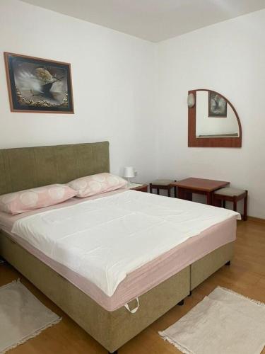 a bedroom with a large bed in a room at Apartments Maja in Lopar