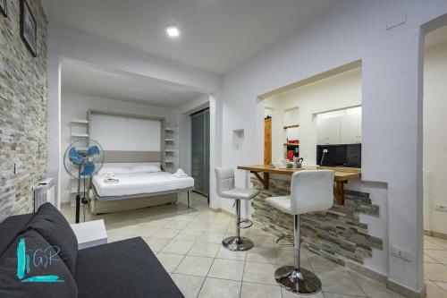a kitchen and a living room with a table and a bed at Chiabrera11 Aquarium - Genovainrelax in Genova