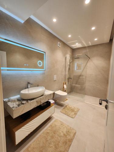 a bathroom with a sink and a shower at sea and sun luxury apartment in Ulcinj