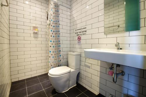 a bathroom with a toilet and a sink at 3 Laan House in Chiang Mai