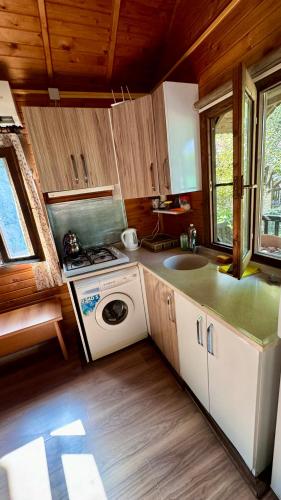 a kitchen with a washing machine and a sink at Villa Balım in Koycegiz