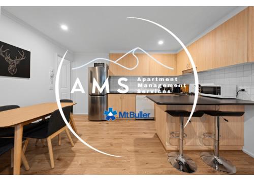 a kitchen with a table and a counter top at Candoux 9 AMS Mt Buller in Mount Buller