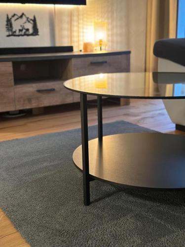 a coffee table in a living room with a tv at Cozy Lodge in Bivio 20 Minutes from St Moritz in Bivio