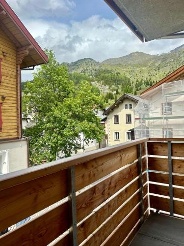 a balcony with a fence and mountains in the background at Cozy Lodge in Bivio 20 Minutes from St Moritz in Bivio