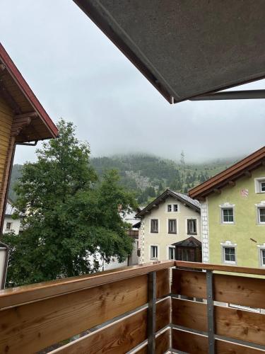 a balcony with a view of some buildings at Cozy Lodge in Bivio 20 Minutes from St Moritz in Bivio