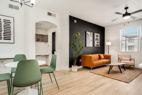 a living room with a table and chairs and a couch at Boulevard Stays Luxe 1BR by Stadium Pool Parking Gym 07 in Glendale