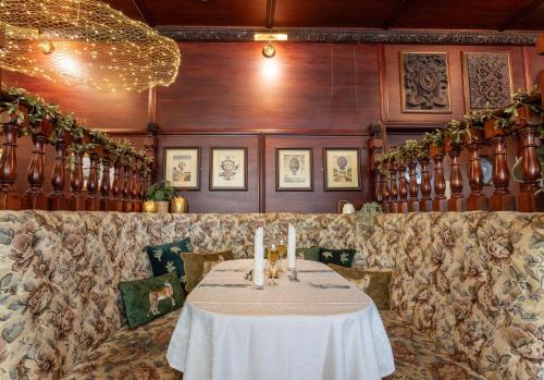 a dining room with a table with candles on it at Durrant House Hotel in Bideford