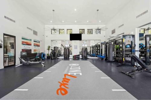 a gym with a gym sign on the floor at Boulevard Stays Luxe 2BR by the Stadium Pool Parking Gym 05 in Glendale