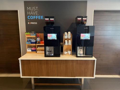 a coffee shop with a coffee machine on a counter at Holiday Inn Express Hotel & Suites Altoona-Des Moines by IHG in Altoona