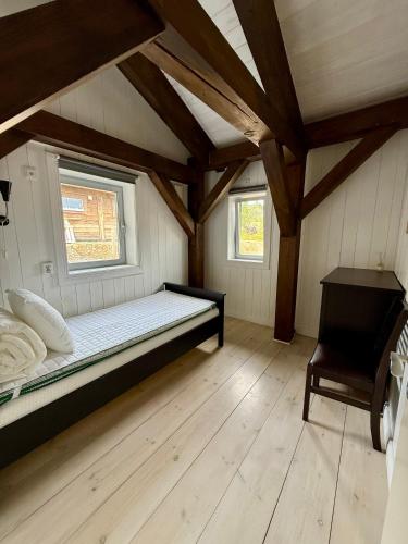 a bedroom with a bed in a room with wooden floors at Fjallhus Storhogna 2 in Storhågna
