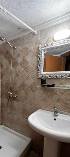 a bathroom with a sink and a mirror at Halkidiki Kallithea Family House across the beach in Kallithea Halkidikis