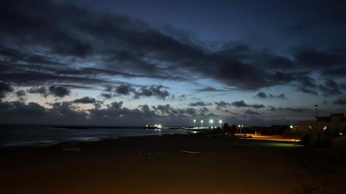 a beach at night with a cloudy sky and the ocean at Onda Kriola in Vila do Maio