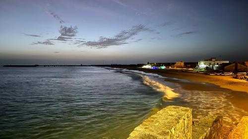 a view of a beach at night with the ocean at Onda Kriola in Vila do Maio