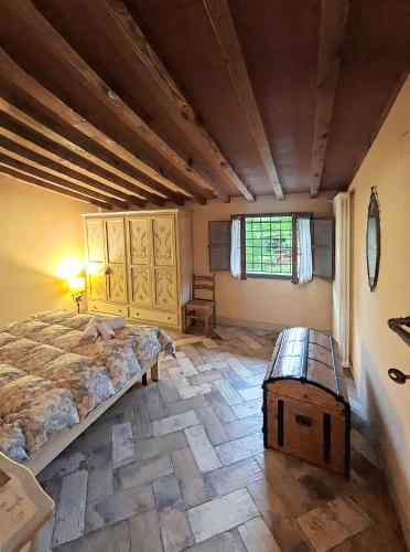 a bedroom with a large bed and a wooden table at Bioagriturismo Podere Ruggeri in Pontassieve