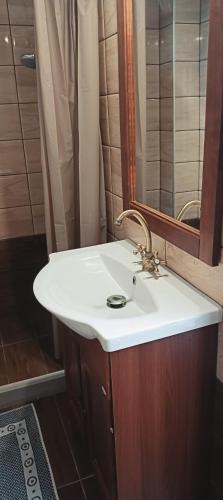 a bathroom with a sink and a mirror at Archanes grandma's house in Archanes
