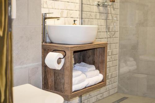 a bathroom with a sink and a bunch of towels at Vila Intre Lacuri in Sovata